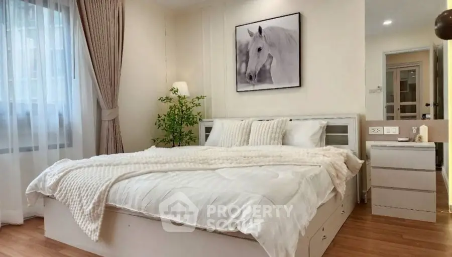 Elegant bedroom with cozy decor and natural light