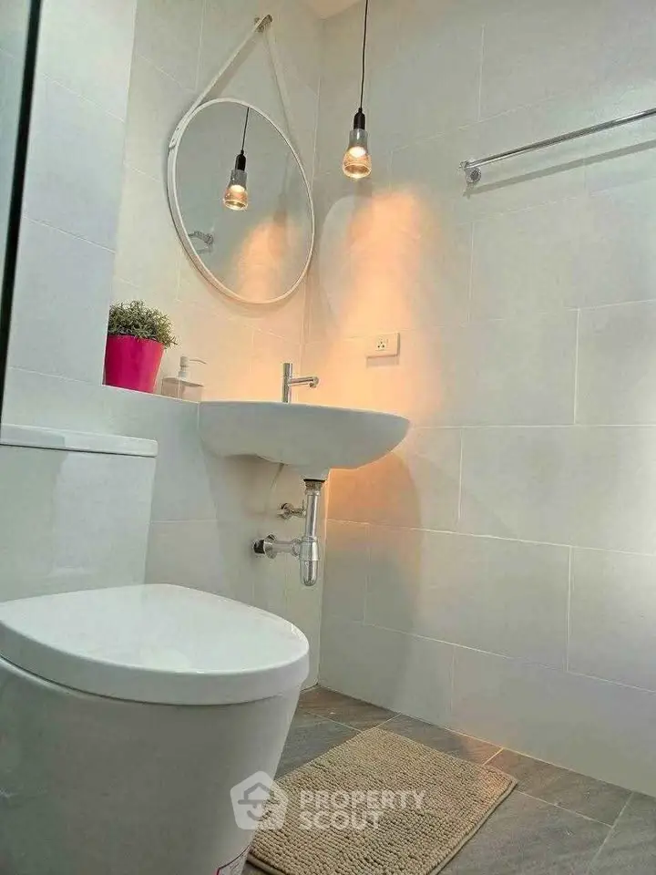 Modern bathroom with sleek fixtures and stylish lighting, perfect for a contemporary home.