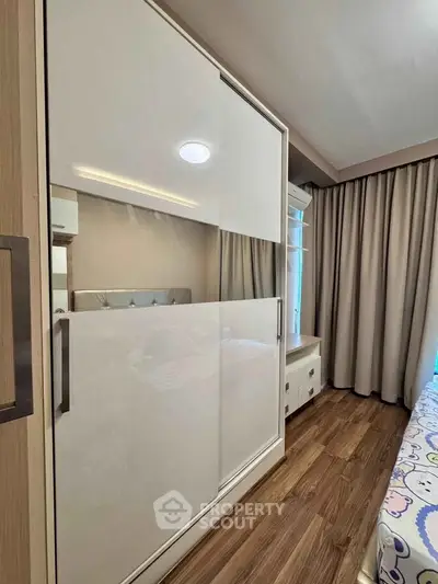Modern bedroom with sleek wardrobe and cozy decor