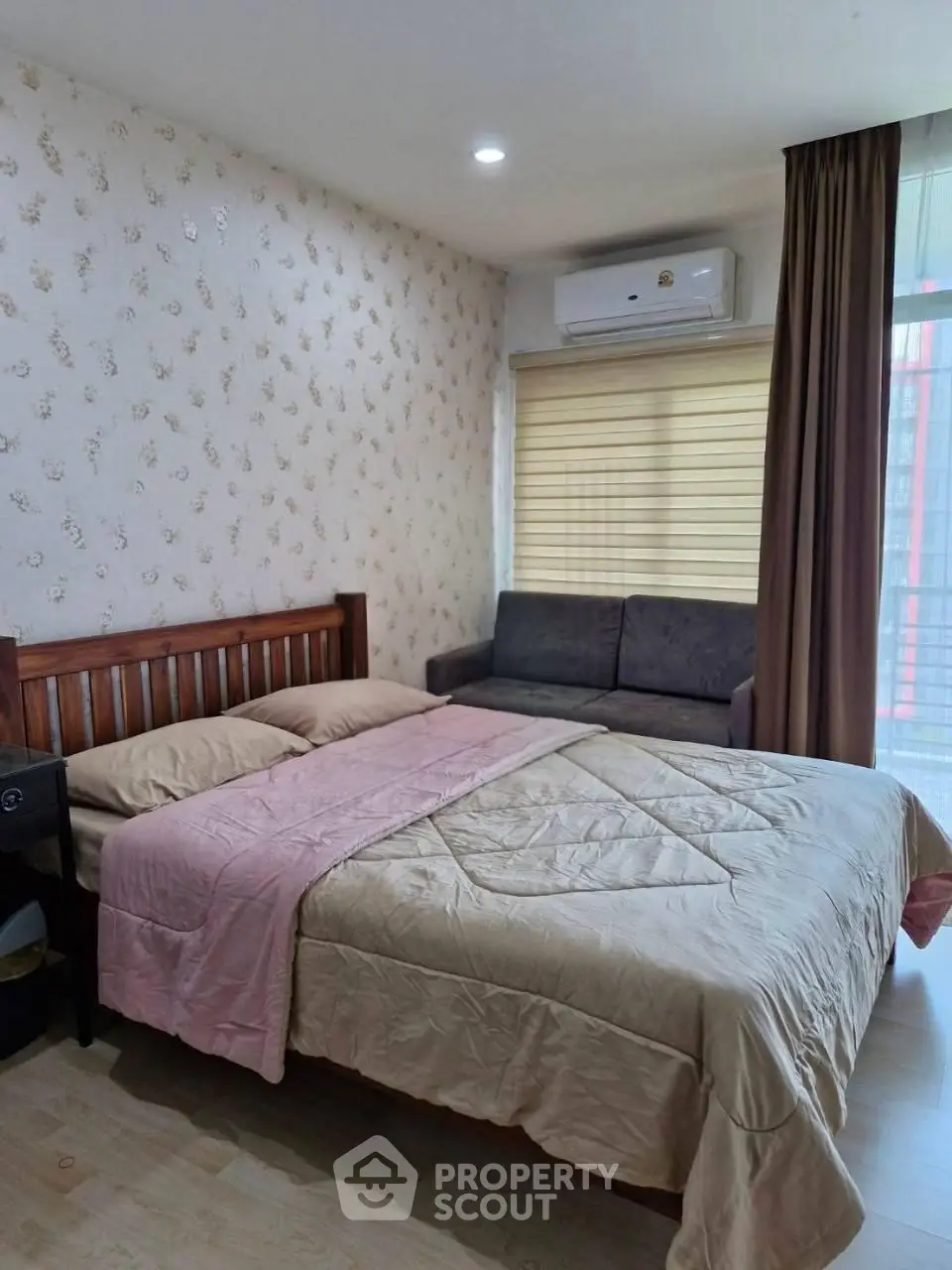 Cozy bedroom with stylish wallpaper, comfortable bed, and modern air conditioning unit.