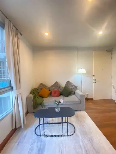Cozy living room with modern decor and natural light, featuring a stylish sofa and coffee table.