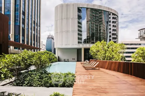 Luxurious rooftop pool with modern architecture and lush greenery in urban setting.