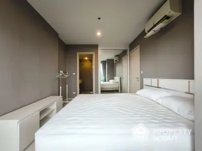 Modern bedroom with minimalist design and air conditioning in a stylish apartment.