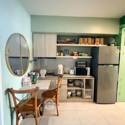 Charming kitchen with modern appliances and cozy dining area, perfect for culinary enthusiasts.