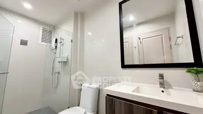 Modern bathroom with sleek fixtures and large mirror
