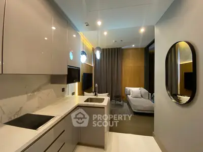 Modern open-layout kitchen with sleek cabinetry and cozy living area