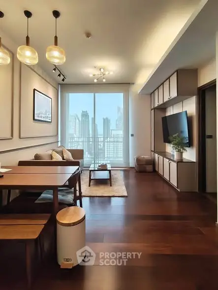 Modern living room with city view, elegant lighting, and stylish furniture in a high-rise apartment.