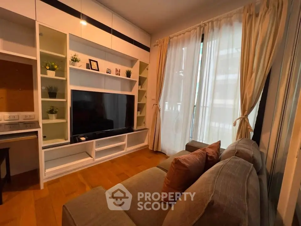 Cozy living room with modern entertainment center and large window view