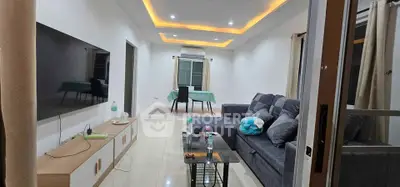 Spacious modern living room with sleek furniture and ambient lighting, perfect for relaxation and entertainment.
