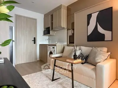 Modern living room with compact kitchen and stylish decor