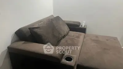 Cozy brown sofa with cup holder in modern living room setting