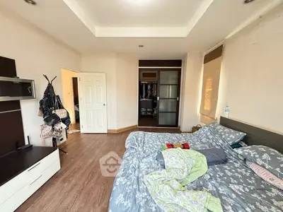 Spacious bedroom with cozy decor and ample closet space