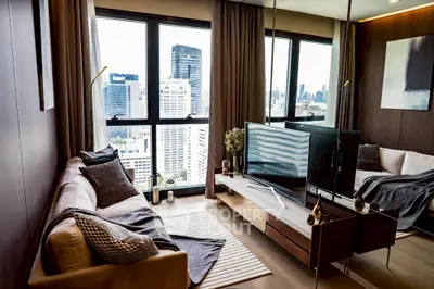 Stylish modern living room with city view, featuring cozy seating and elegant decor.