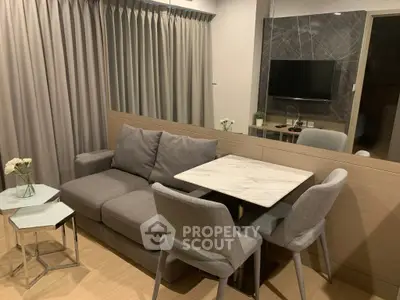 Modern living room with cozy gray sofa and stylish dining area