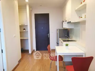 Modern compact kitchen with dining area in cozy apartment