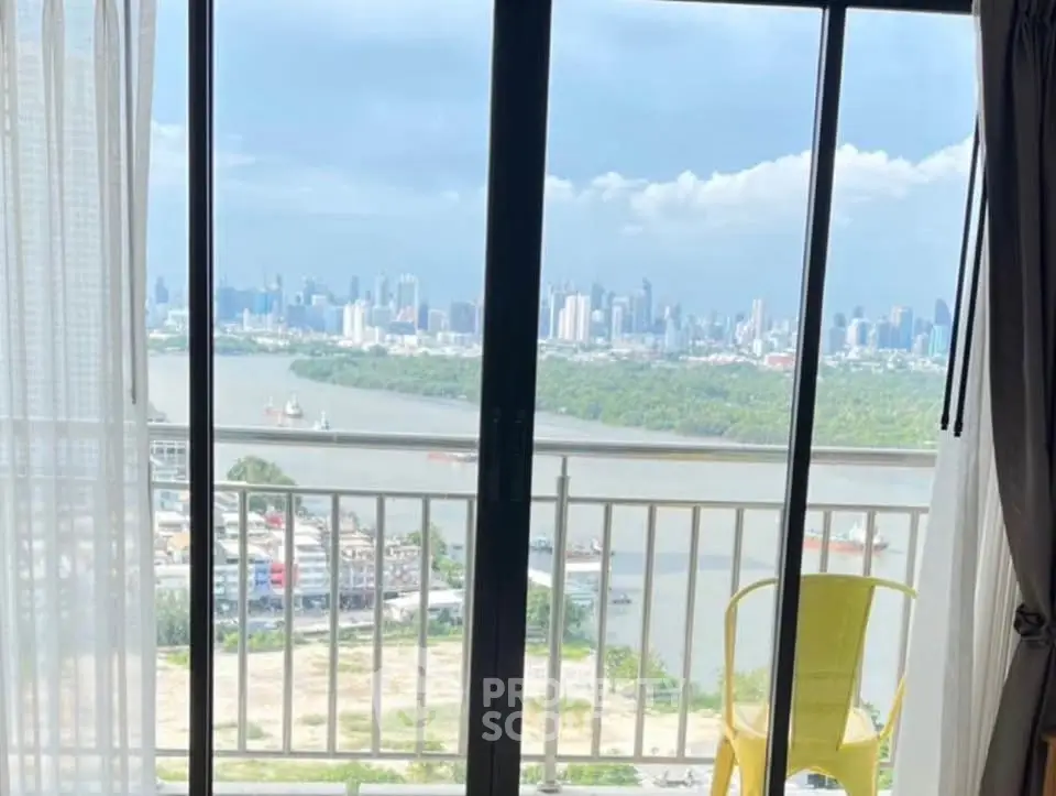 Stunning city skyline view from a high-rise balcony with river scenery.