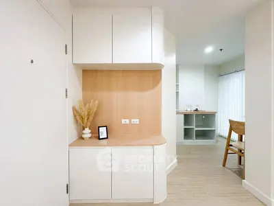 Modern minimalist interior with sleek cabinetry and natural wood accents in a bright living space.