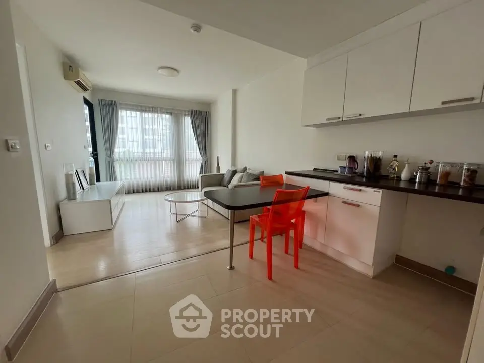 Modern living room with open kitchen and stylish decor in a bright apartment