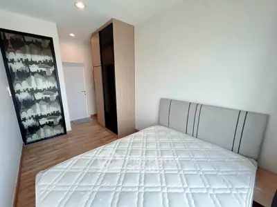 Modern bedroom with stylish decor and comfortable bed in a contemporary apartment.