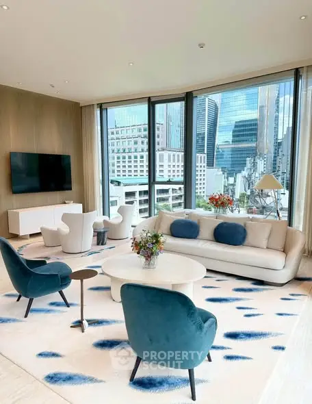 Luxurious living room with stunning city view, modern furniture, and floor-to-ceiling windows in a high-rise apartment.