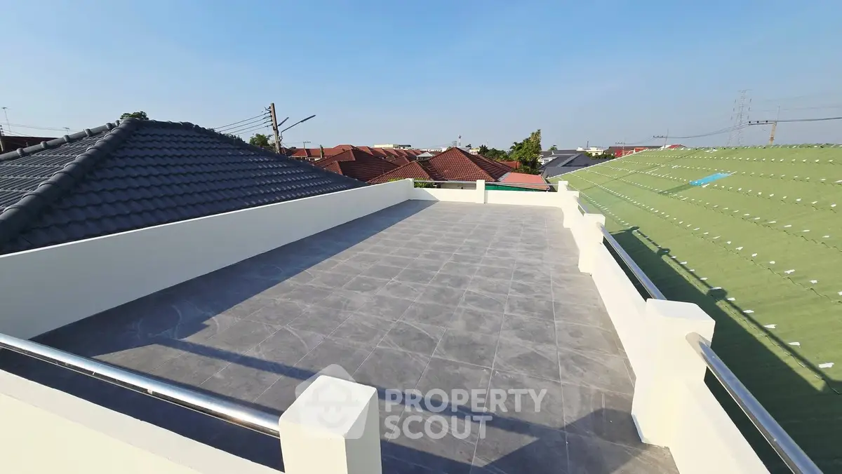 Spacious rooftop terrace with panoramic views and modern railing design.