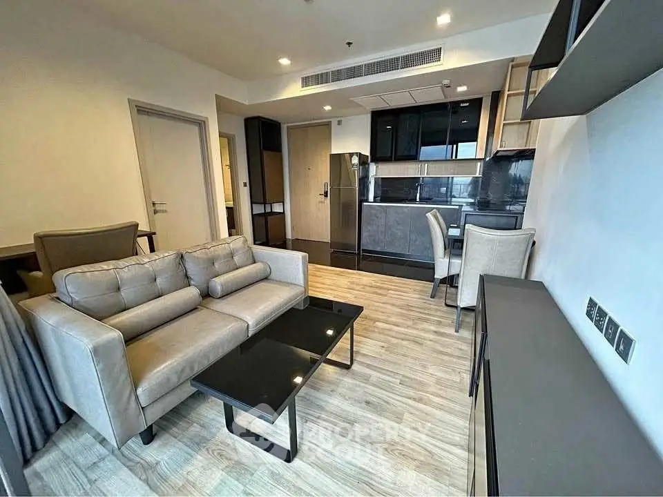 Modern open-plan living room with sleek kitchen and stylish furnishings