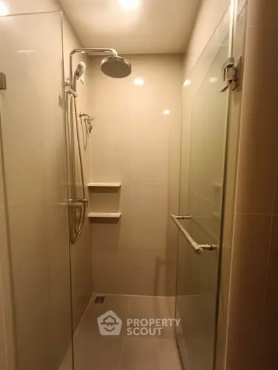 Modern bathroom with glass shower enclosure and sleek fixtures