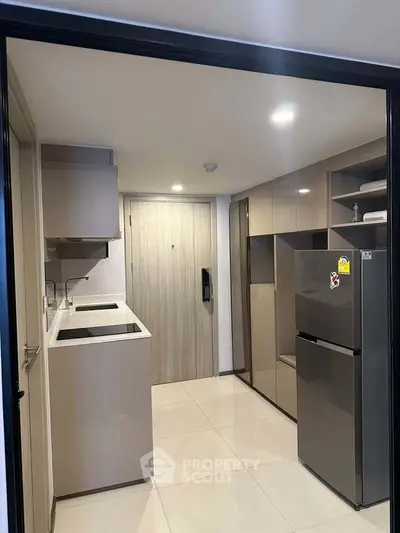 Modern kitchen with sleek cabinetry and stainless steel appliances in a compact layout.