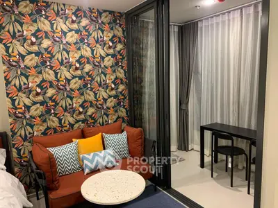 Chic living room with vibrant floral wallpaper and cozy seating area, perfect for modern urban living.