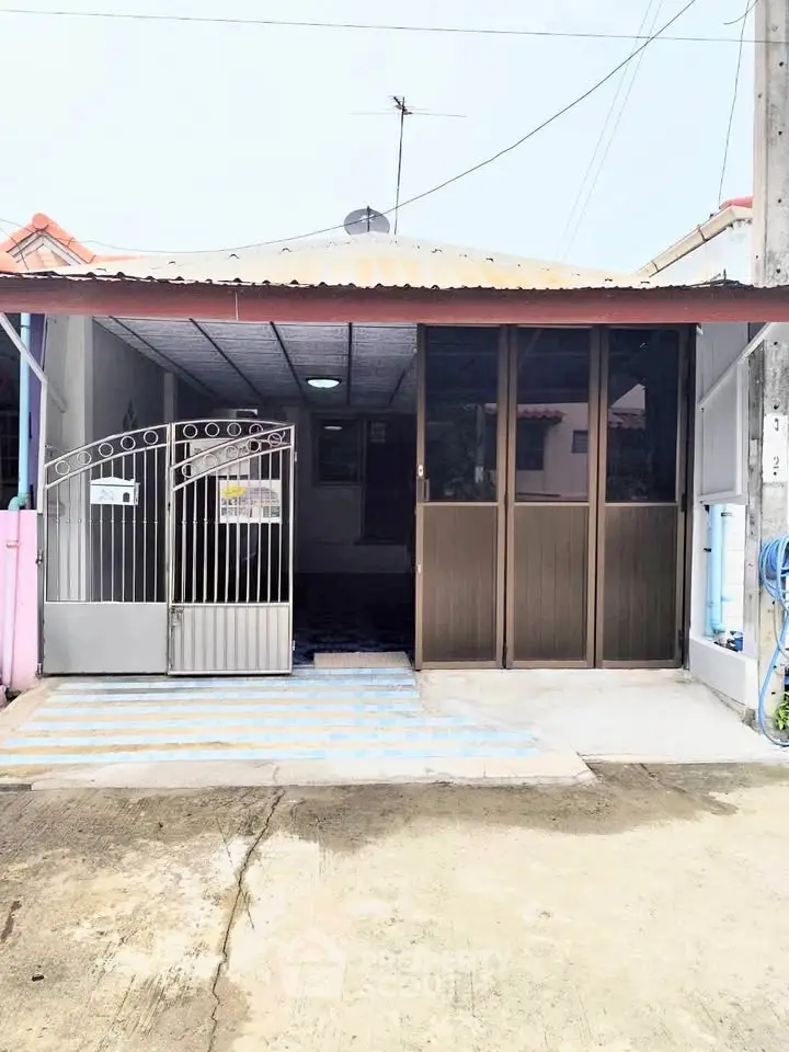 Charming single-story home with gated entrance and covered parking area.