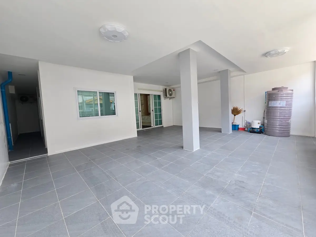 Spacious covered parking area with tiled flooring and modern design.