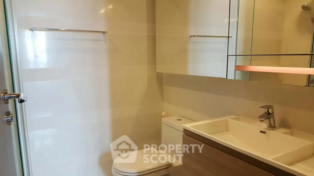 Modern bathroom with sleek fixtures and large mirror