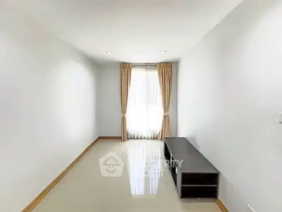 Spacious minimalist living room with natural light and modern decor