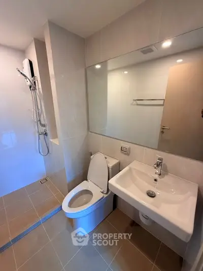 Modern bathroom with sleek fixtures and spacious shower area