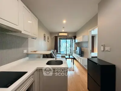 Modern open-layout kitchen and living room with sleek design and city view balcony.