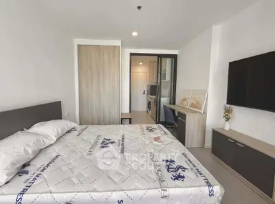 Modern bedroom with stylish decor and in-unit laundry facilities