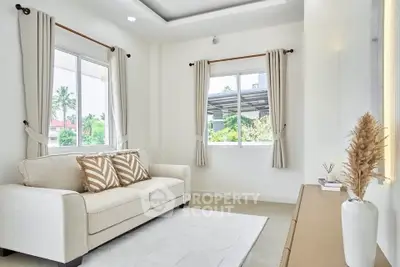 Bright and airy living room with elegant decor and large windows.