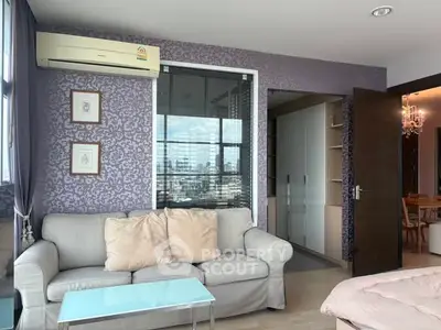 Stylish living room with city view, elegant decor, and cozy seating area.