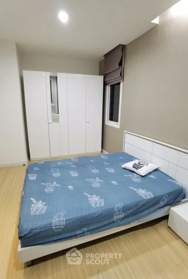 Modern bedroom with stylish decor and ample storage space