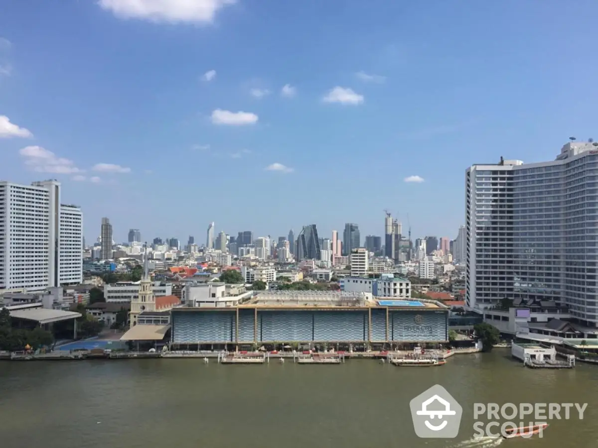 Stunning cityscape view with riverfront buildings and skyline under clear blue sky.