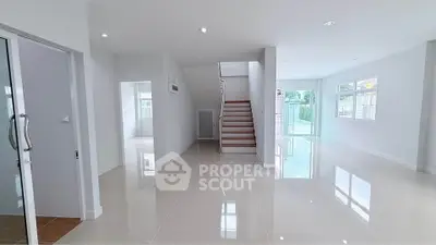 Spacious modern living room with glossy tile flooring and natural light.