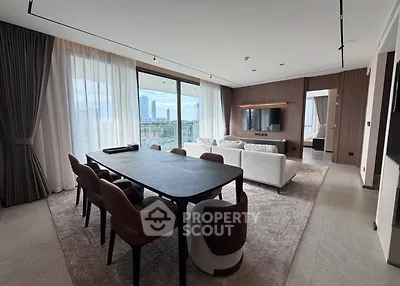 Luxurious modern living room with elegant dining area and stunning city view.