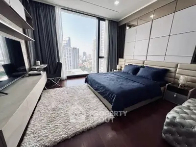 Luxurious modern bedroom with city view, elegant decor, and plush furnishings in high-rise apartment.
