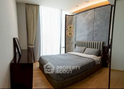 Luxurious modern bedroom with elegant design and floor-to-ceiling windows.