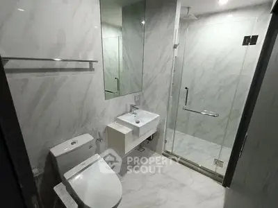 Modern bathroom with glass shower and sleek fixtures