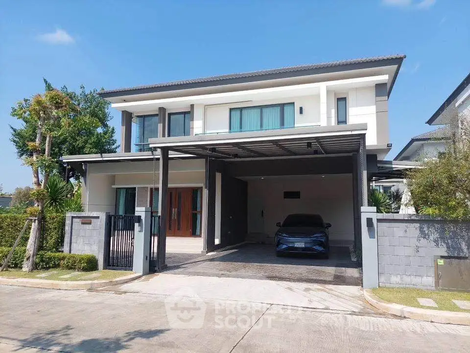 Modern two-story house with carport and sleek design in a suburban neighborhood.