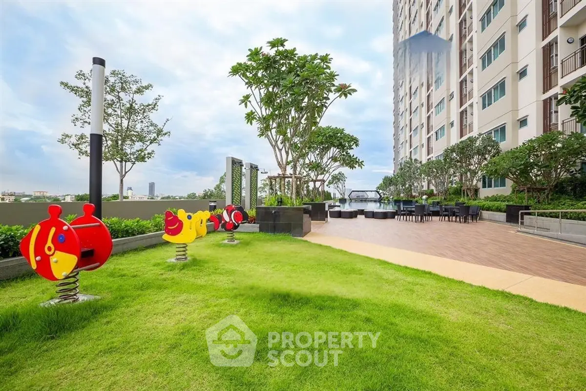Modern apartment building with lush garden and children's play area