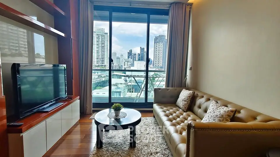 Stylish living room with city view, featuring modern furniture and large windows for natural light.