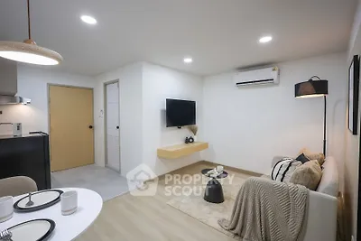 Modern living room with cozy decor and wall-mounted TV