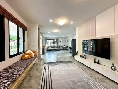 Spacious modern living room with stylish decor and large windows